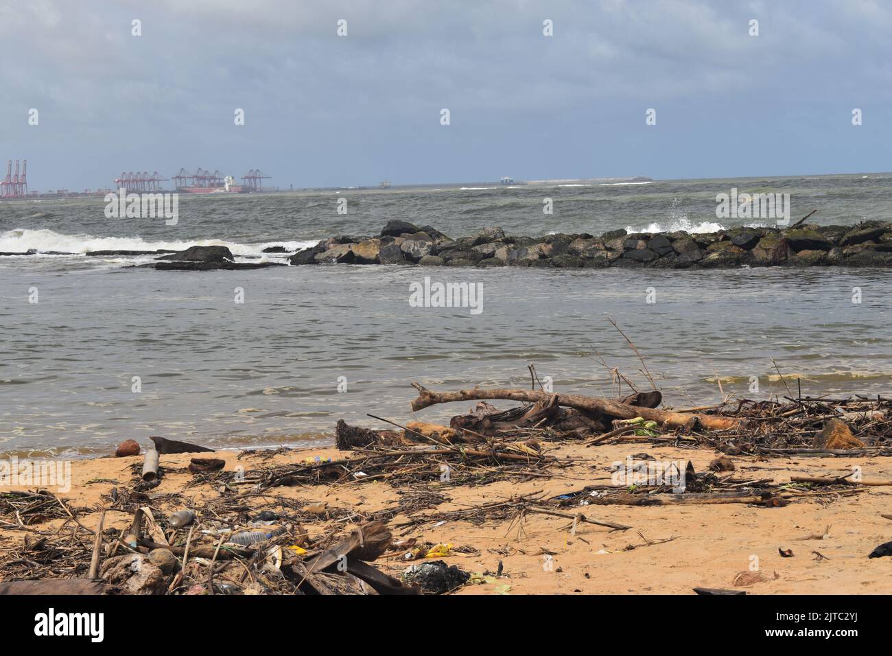 Wood and plastic wastage has washed ashore due to rough seas in the Indian ocean in the outskirts of Colombo. Sri Lanka. Stock Photo
