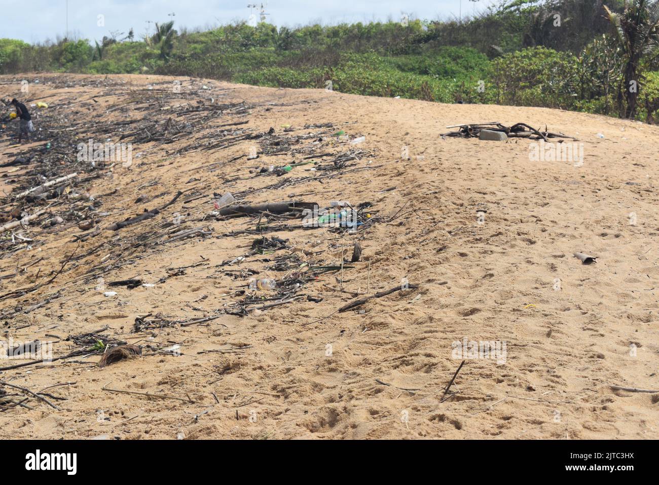 Wood and plastic wastage has washed ashore due to rough seas in the Indian ocean in the outskirts of Colombo. Sri Lanka. Stock Photo