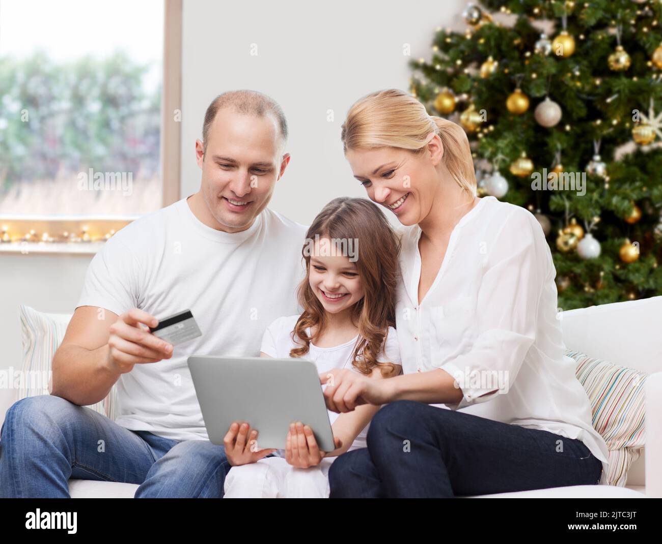 family with tablet pc and credit card on christmas Stock Photo