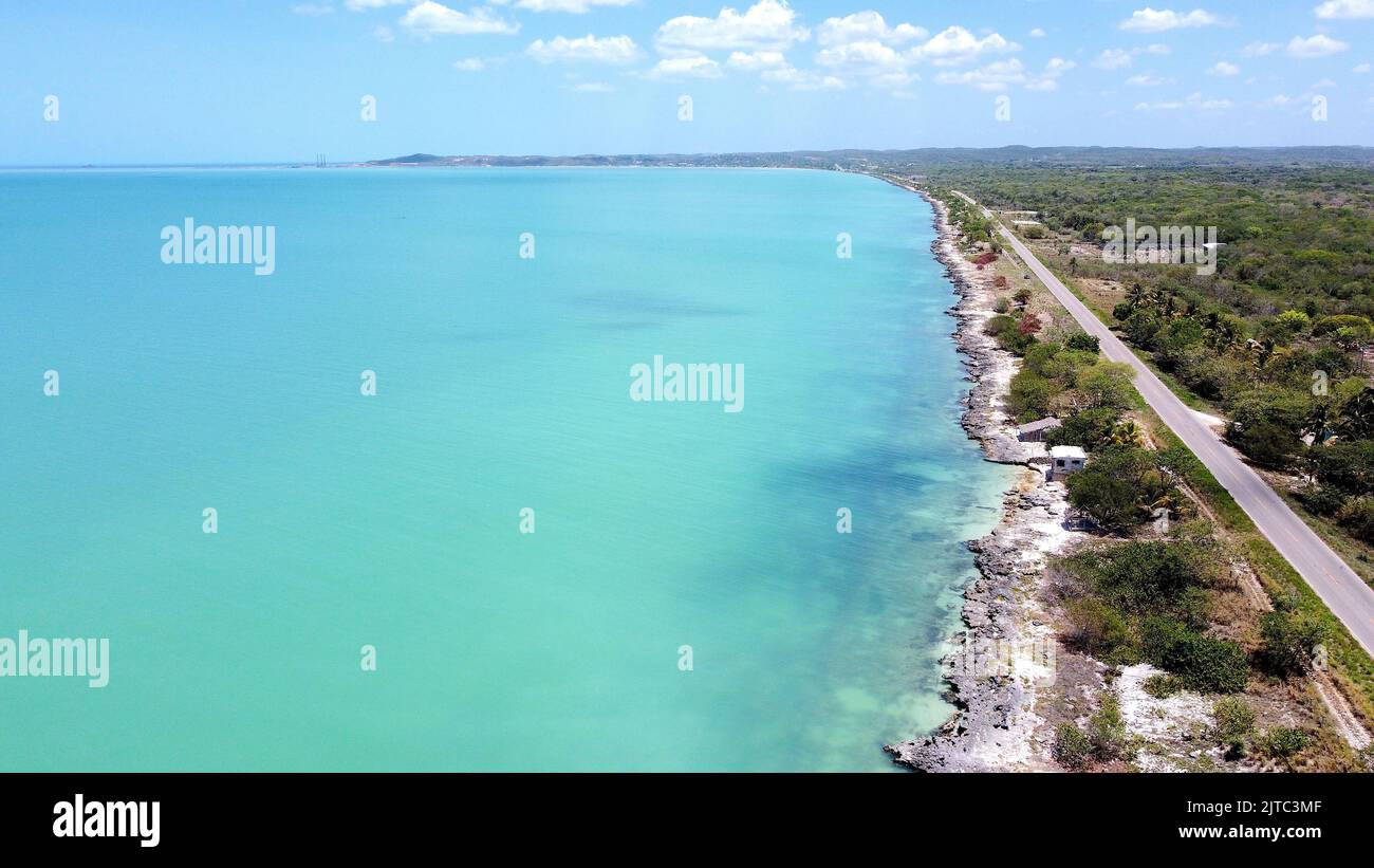 An aerial view of an ocean with coast on the right side in Campeche