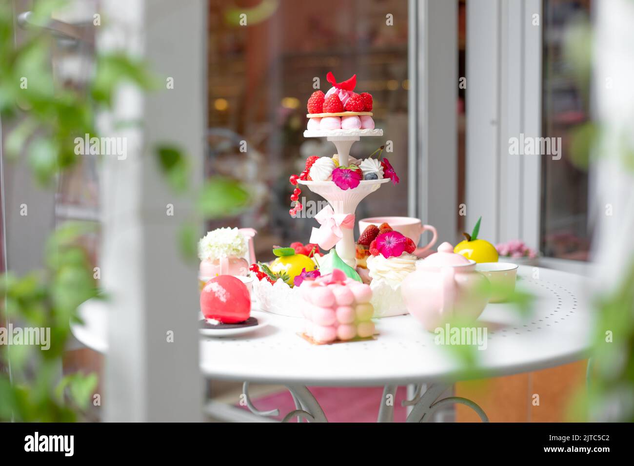 Sweet sugar strawberry dessert treats on white table in cafe or candy
