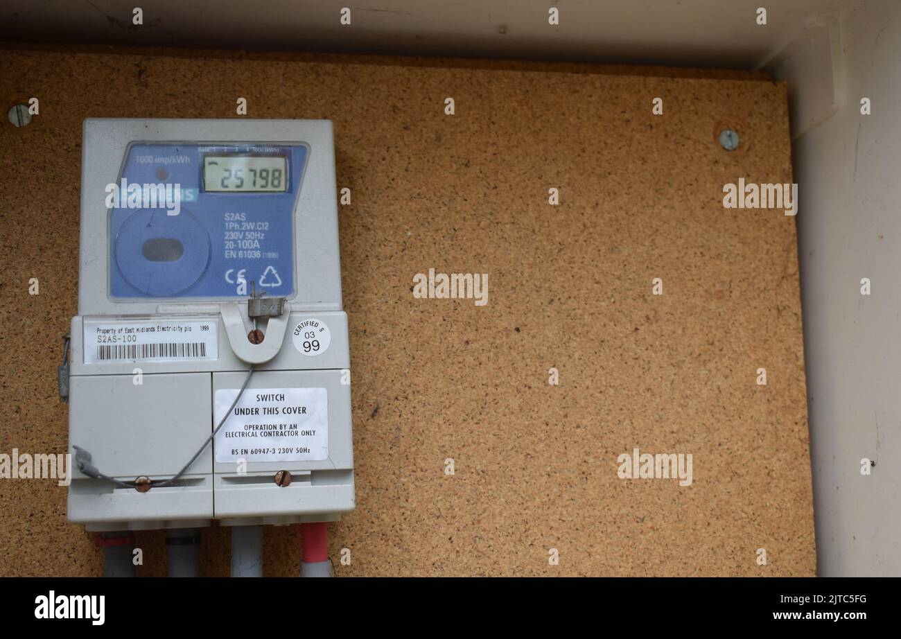 An electricity meter in a meter cupboard with copyspace. Stock Photo