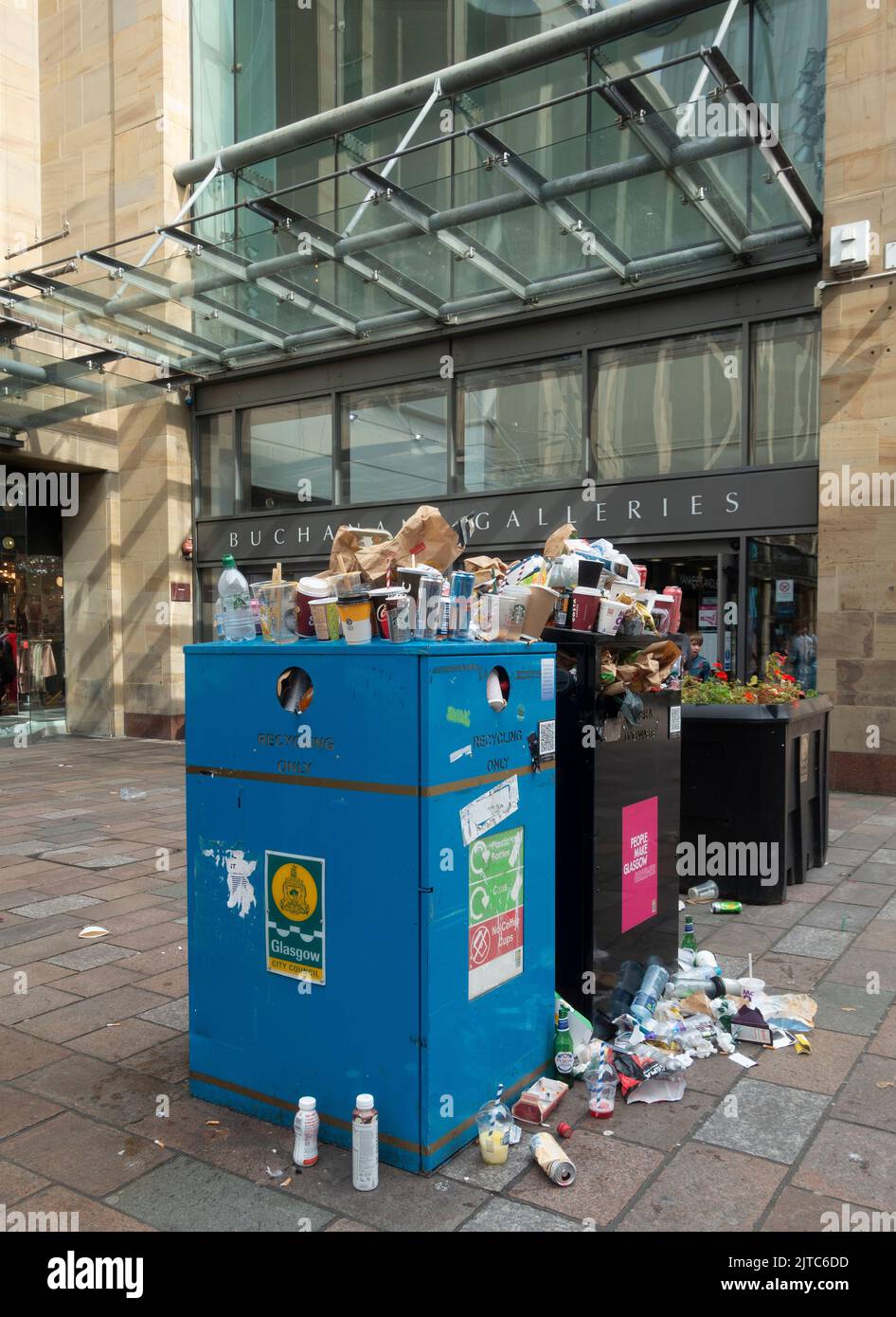 Overflowing litter bin with many full plastic bags on the pavement outside Buchanan Galleries, central Glasgow, during a strike by garbage collectors, Stock Photo