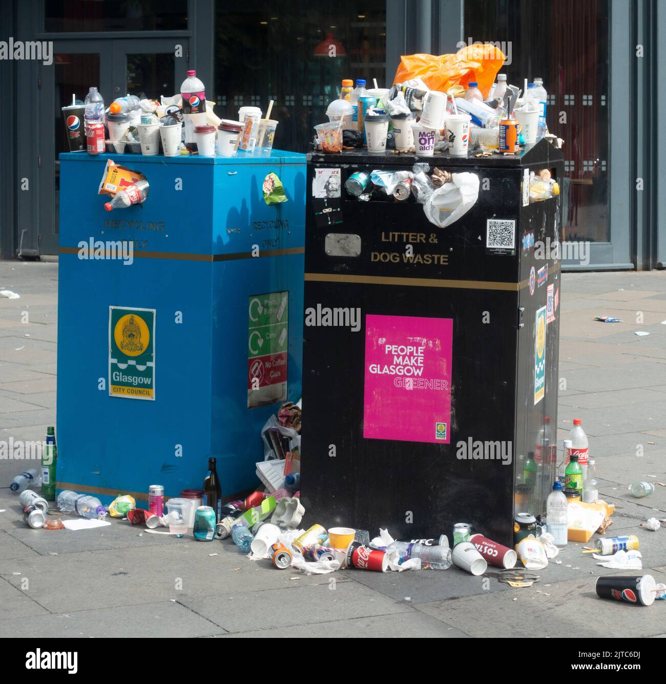 Overflowing litter bins with full plastic bags on the pavement outside Buchanan Bus Station,l Glasgow, during a strike by Council garbage collectors. Stock Photo