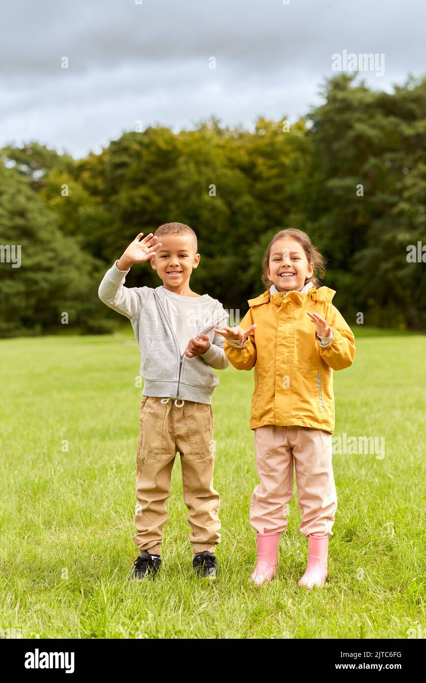 happy little boy and girl at park Stock Photo - Alamy