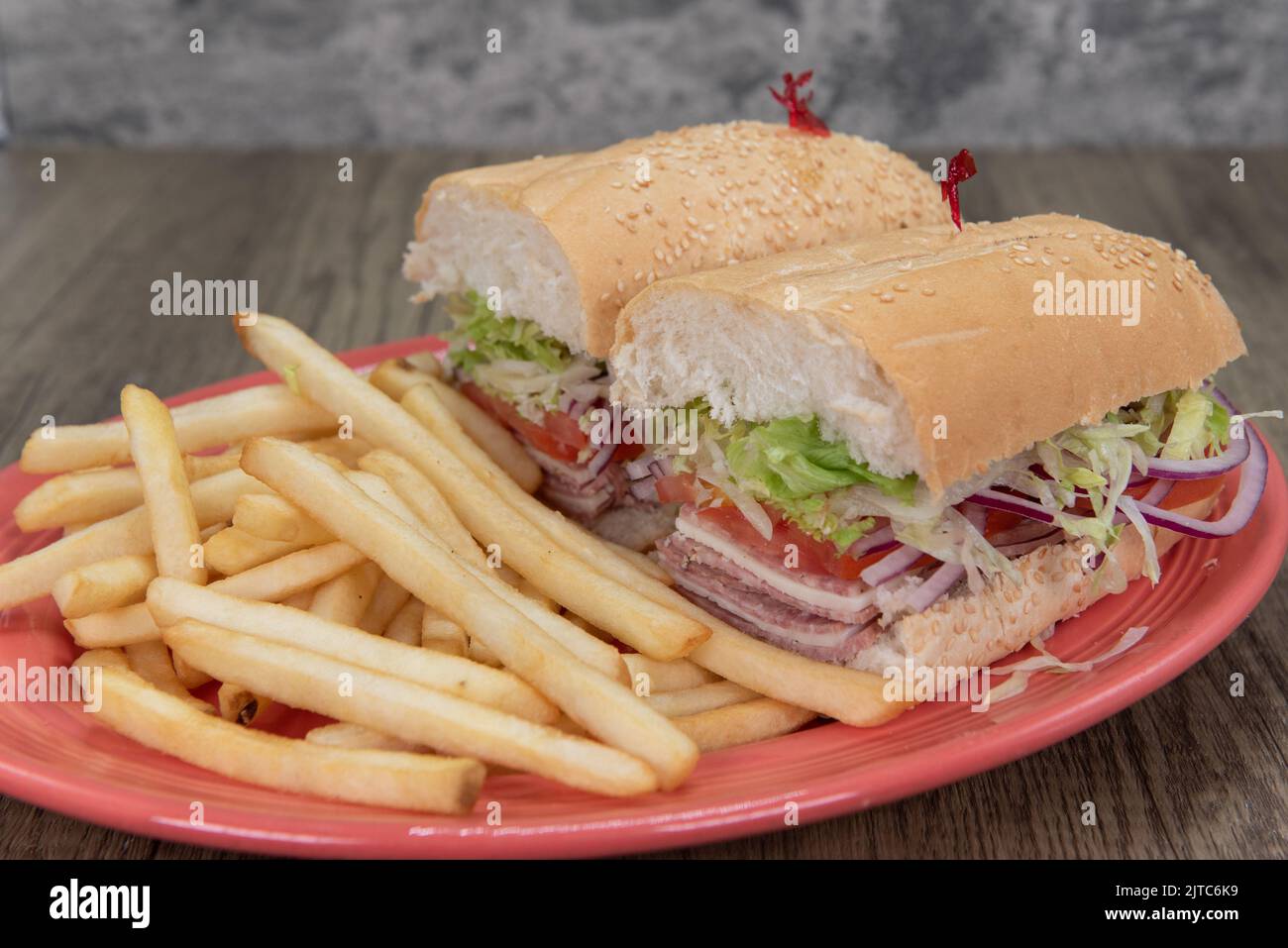 Enormous Italian cold cuts sandwich is loaded with cotto salami