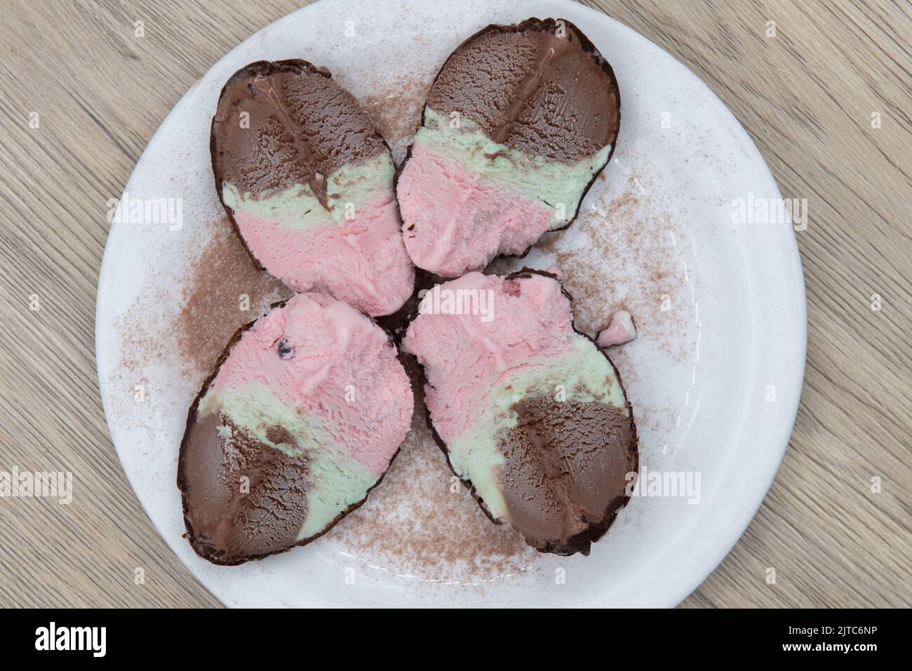 Overhead view of authentic Italian cuisine dessert of spumoni cut into quarters and presented beautifully on a garnished plate. Stock Photo