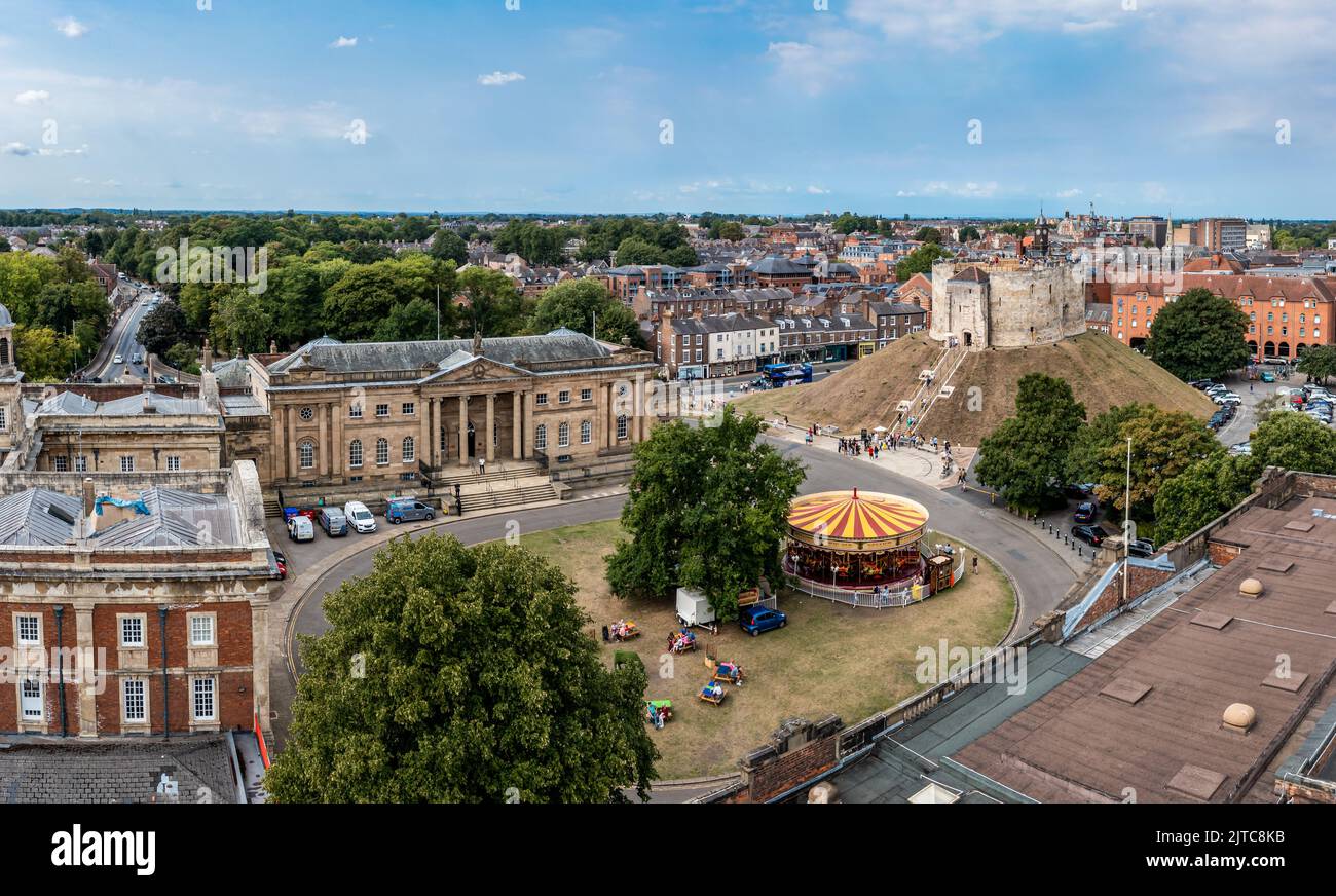 YORK, UK - AUGUST 28, 2022.  An aerial view of Clifford's Tower and The Castle Museum next to the ancient architecture of the Law Courts in York. Stock Photo