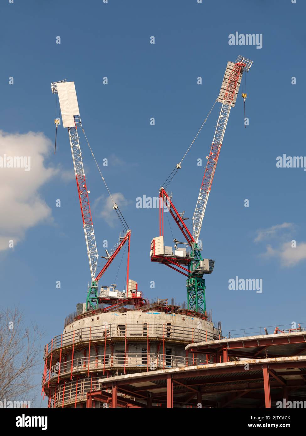 Construction site with many cranes against the sky Stock Photo - Alamy