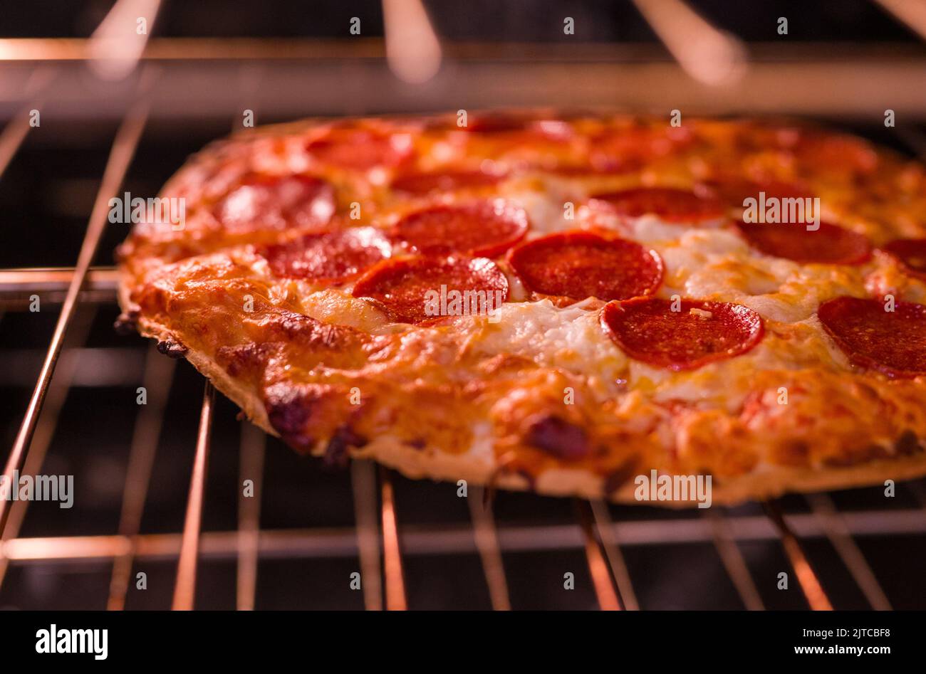 Thin Crust Pizza in the oven Stock Photo Alamy