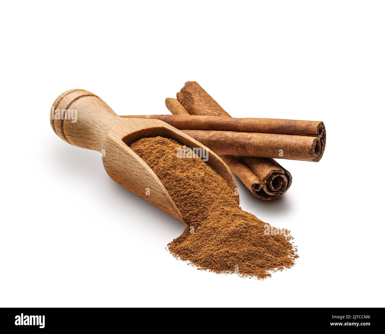 Cinnamon scattered from wooden scoop isolated on white Stock Photo