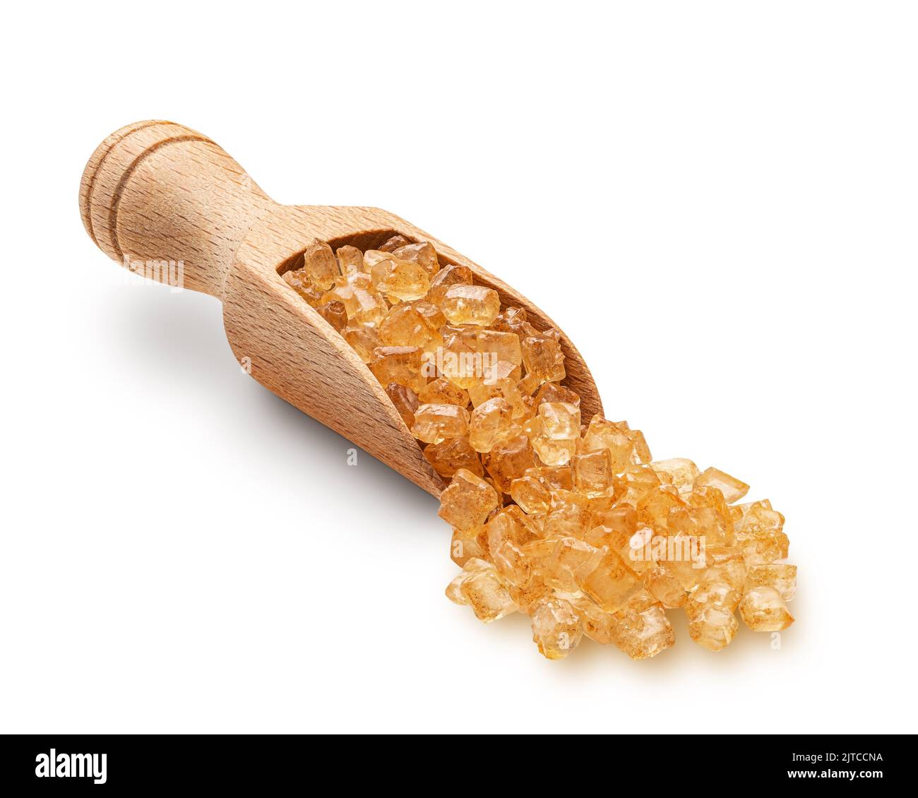 Large brown sugar crystals scuttered from wooden scoop Stock Photo