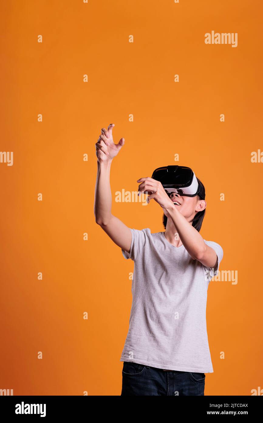 Man in vr headset playing virtual reality games in metaverse. Person in