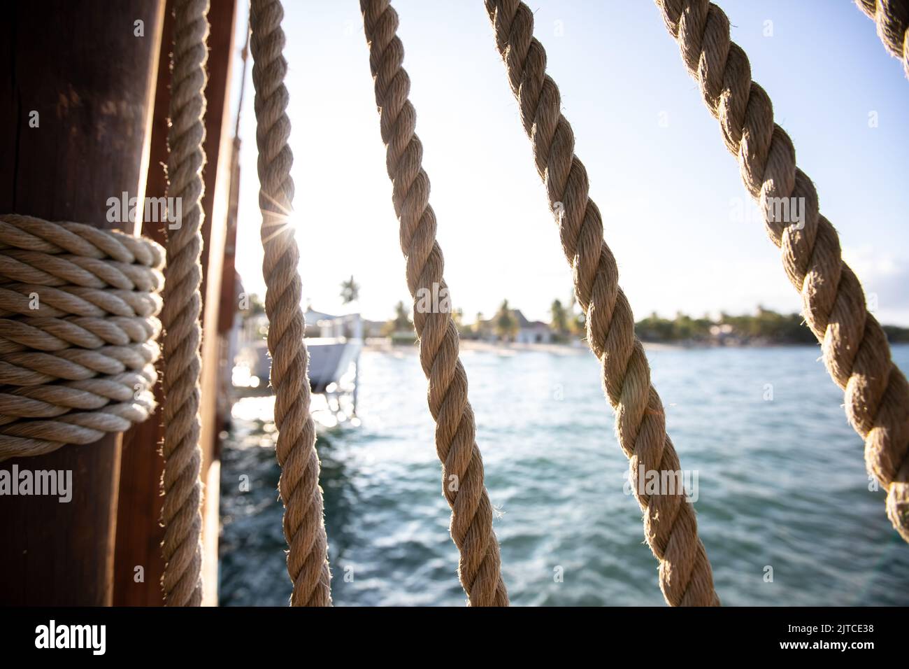 Sunlight coming through ropes on dock in Hopkins Belize Stock Photo