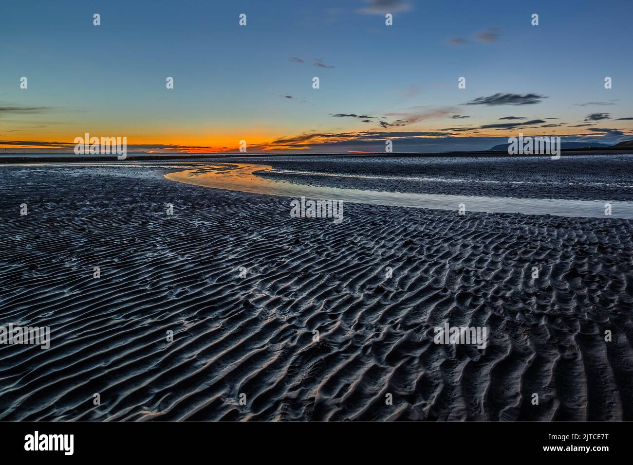 Walney Island, Cumbrian Coast, UK. 29th August 2022. UK Weather. Sunset from Sandy Gap, view towards the distant Black Combe and the Irish Sea. Credit:greenburn/Alamy Live News. Stock Photo