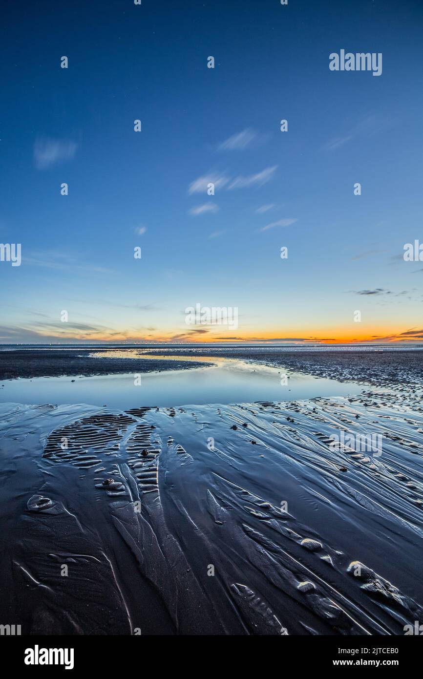 Walney Island, Cumbrian Coast, UK. 29th August 2022. UK Weather. Sunset from Sandy Gap, view towards the distant Black Combe and the Irish Sea. Credit:greenburn/Alamy Live News. Stock Photo