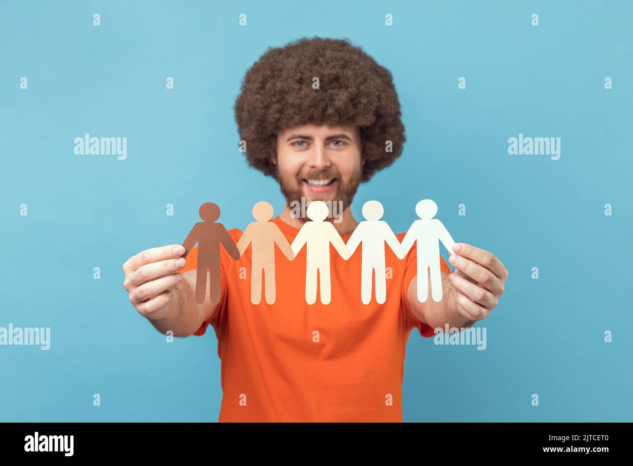 Portrait of happy man with Afro hairstyle wearing orange T-shirt
