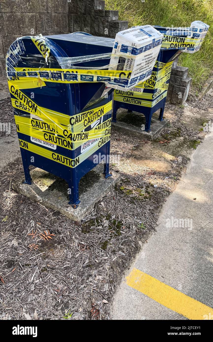 LAWRENCEVILLE, GA - JULY 8, 2022:  Outdoor mail drop boxes at a post office are taped shut and temporarily closed on July 8, 2022 in Lawrenceville, GA. Stock Photo
