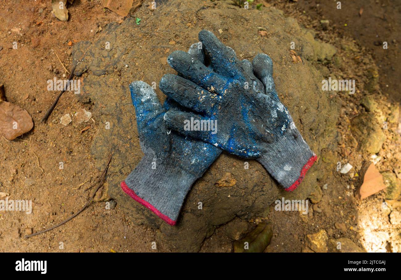 Construction worker, Gardner, painter, gloves worn out due to heavy work Stock Photo