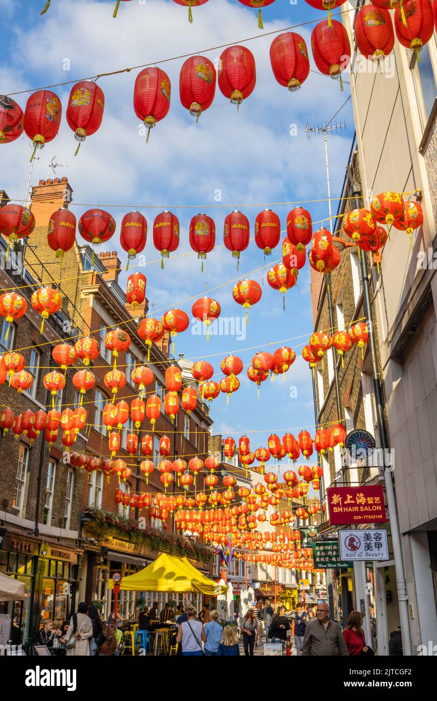 Colourful red and gold Chinese lanterns strung across Lisle Street in Chinatown in the West End of London, City of Westminster WC2 district Stock Photo