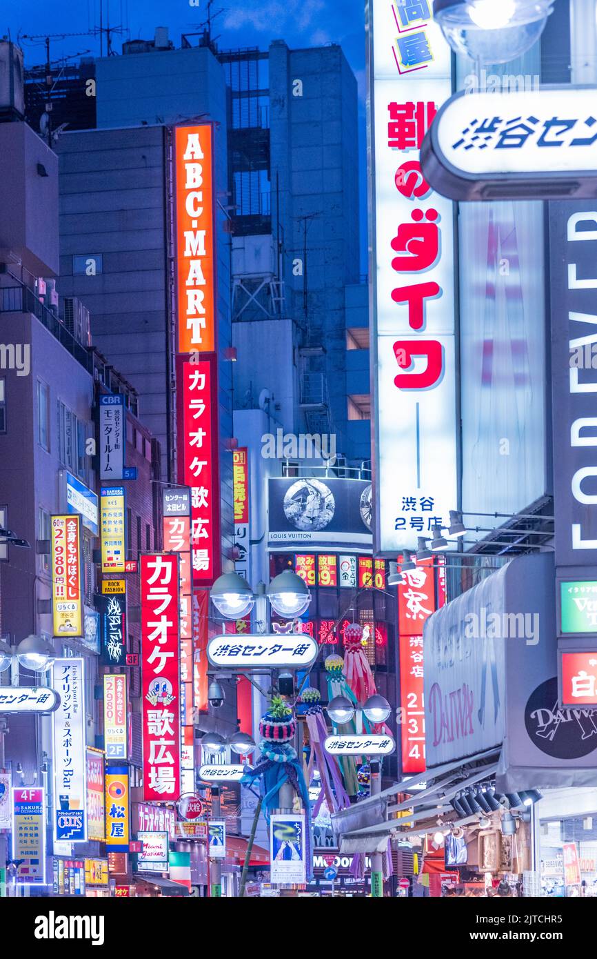 Tokyo, Shibuya, Japan - July 27, 2019: Portrait of Shibuya district at night, illuminated by a lot of billboards.  Stock Photo