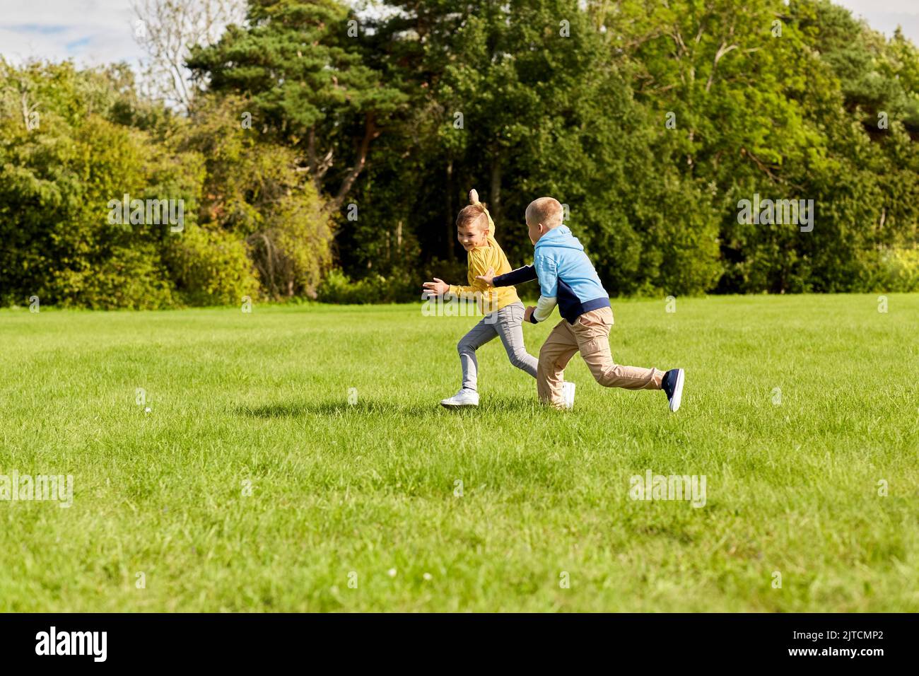 two happy boys playing tag game at park Stock Photo Alamy