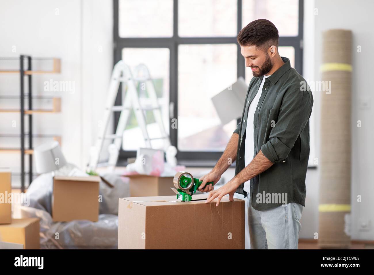 Young man packing out of home hi-res stock photography and images - Alamy