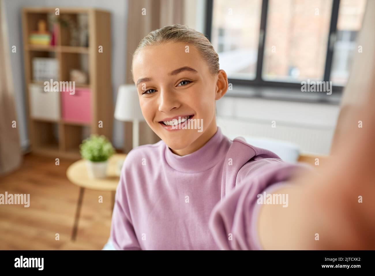 happy smiling girl taking selfie at home Stock Photo - Alamy