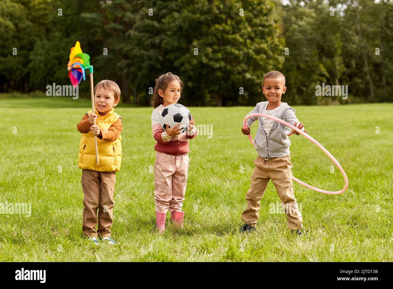 happy kids with pinwheel having fun at park Stock Photo - Alamy