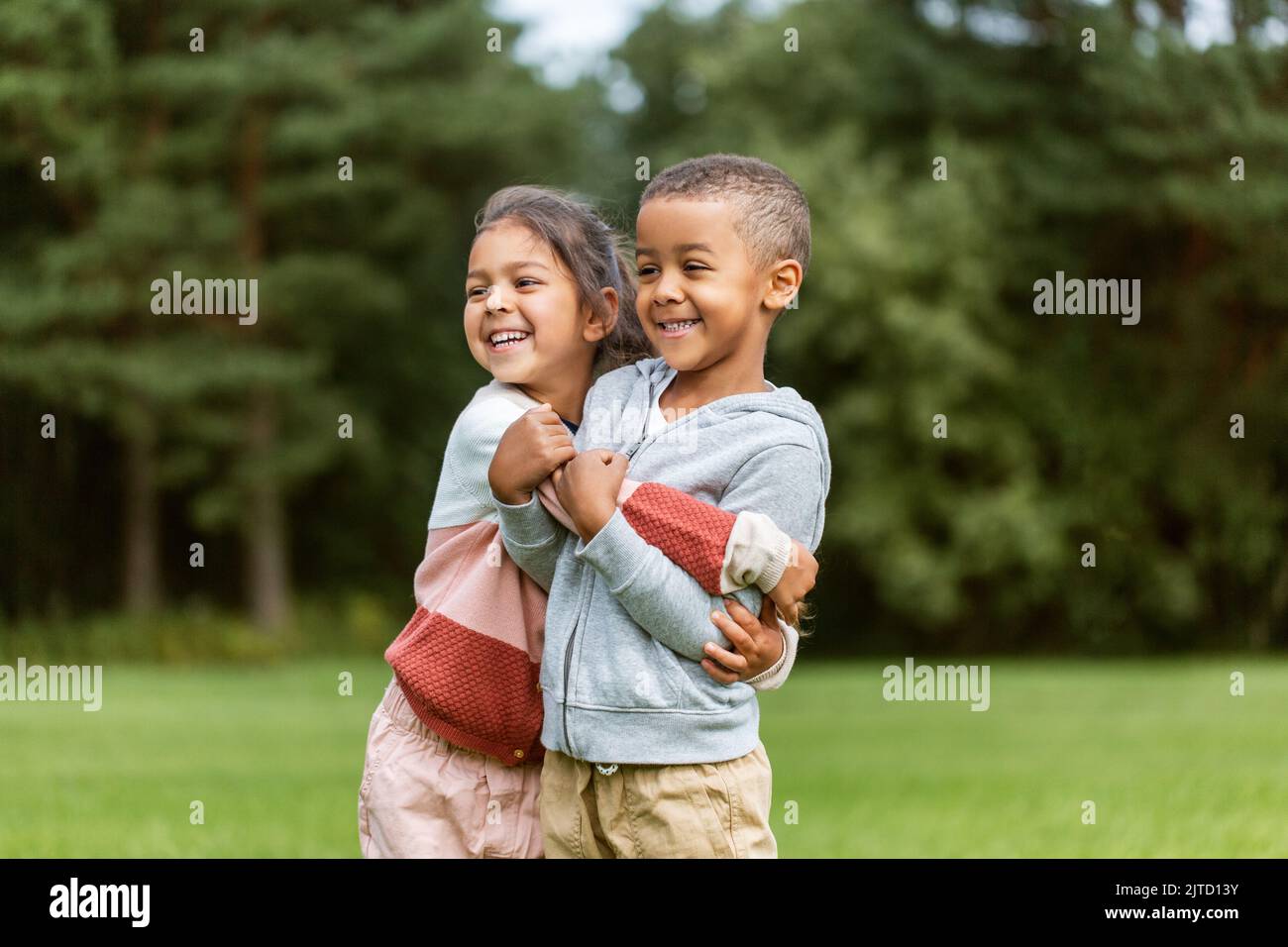 happy little boy and girl hugging at park Stock Photo - Alamy