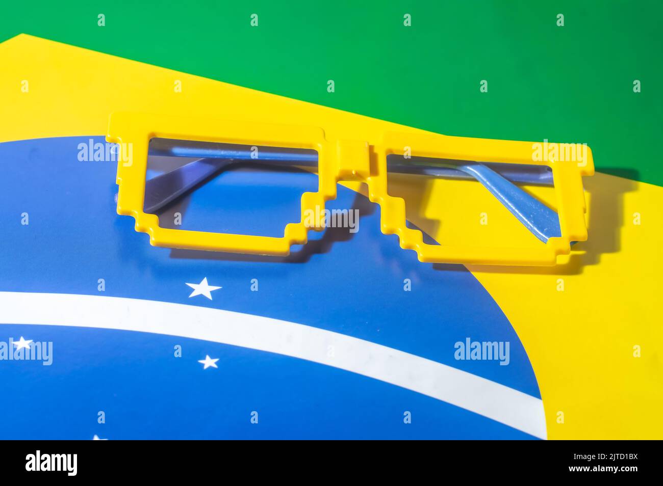 Glasses with Brazil colors, yellow and blue green, world cup concept with yellow background. Stock Photo