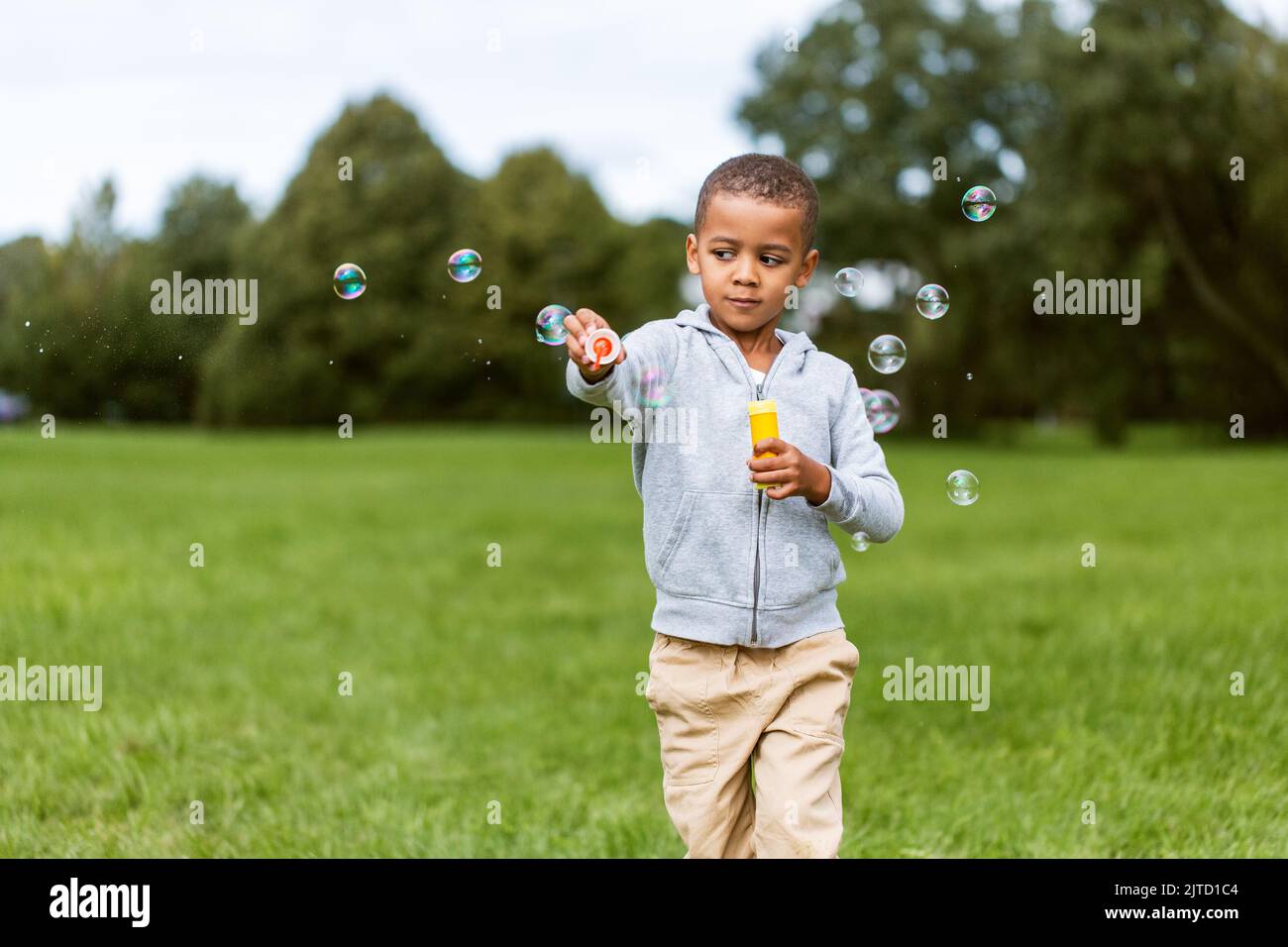 little boy playing with soap bubbles at park Stock Photo - Alamy