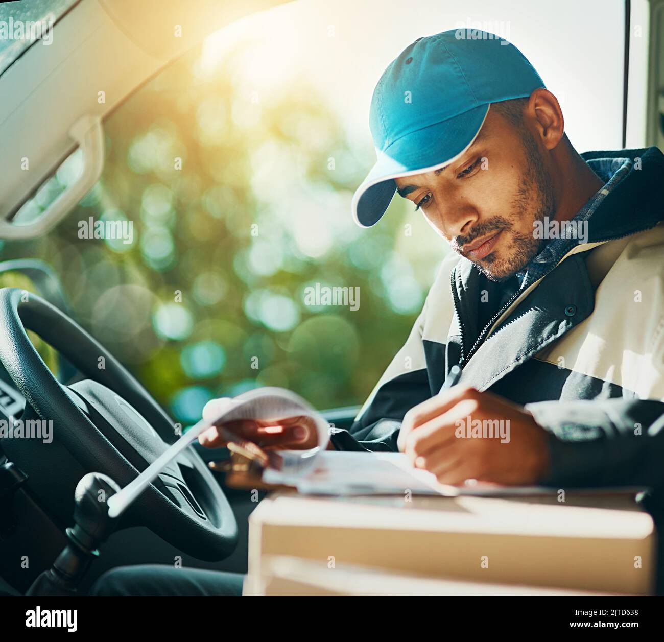 Where to with the next delivery. a courier making deliveries in his van