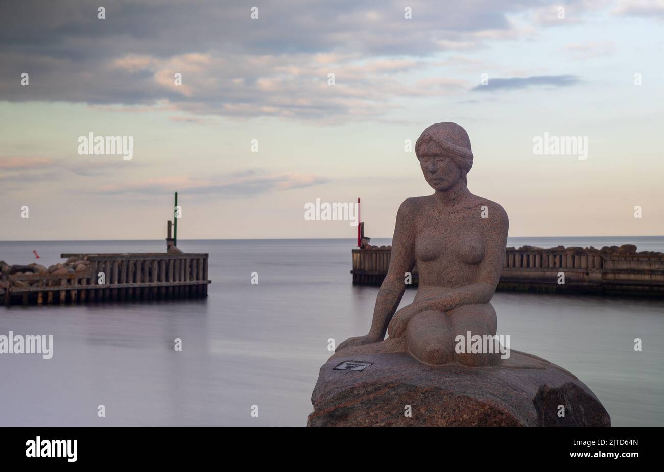 The mermaid statue on the coast of Asaa Docks, Denmark under a cloudy ...