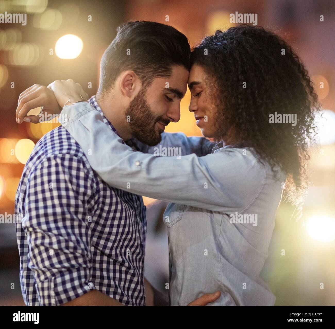 Magic nights under the city lights. an affectionate young couple out on a date in the city. Stock Photo