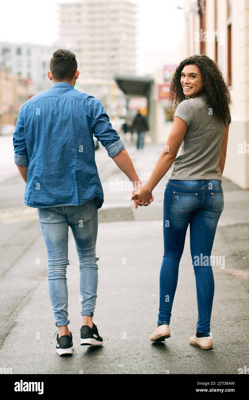 If he holds you hand in public, hes a keeper. a loving couple out in the city. Stock Photo