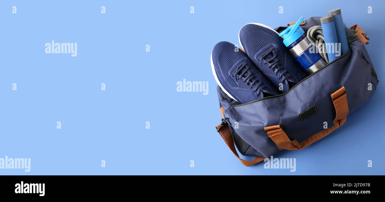 Sports bag on blue background with space for text Stock Photo - Alamy