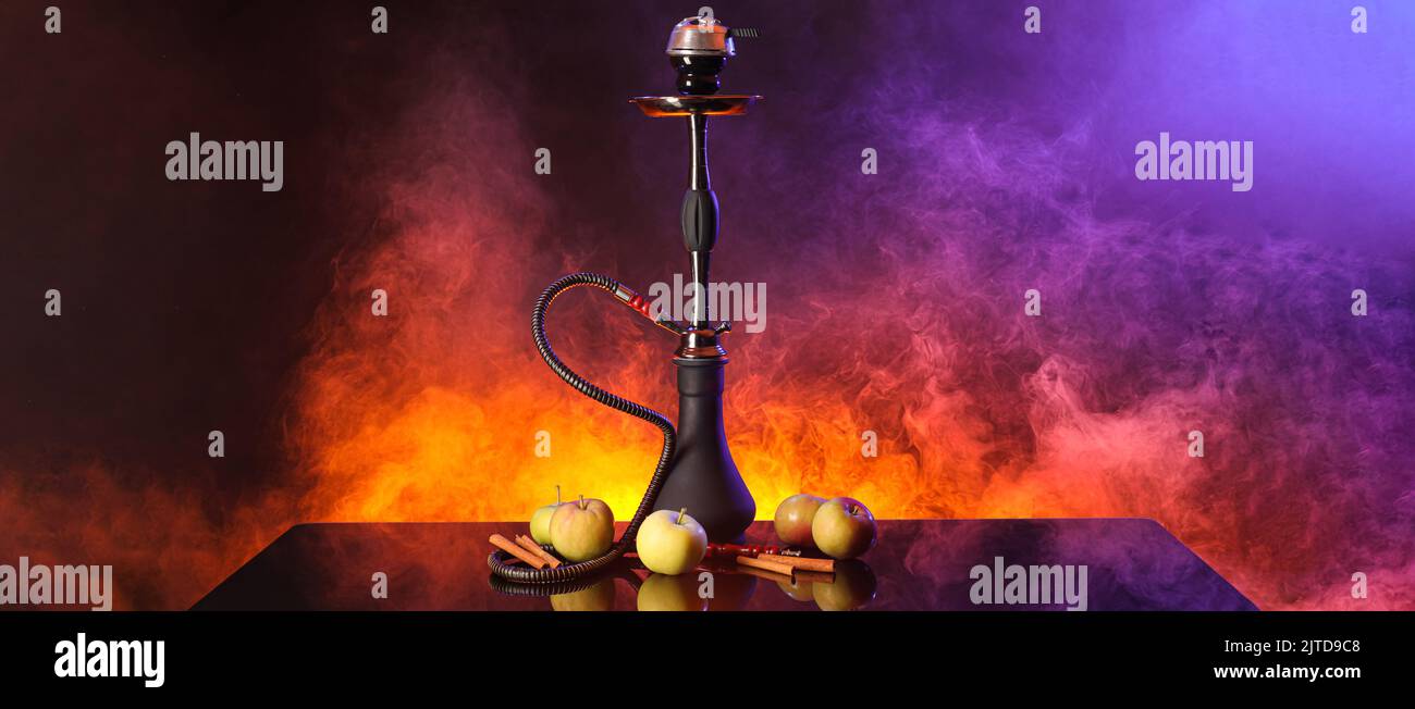 Hookah with apples and cinnamon on dark background Stock Photo - Alamy