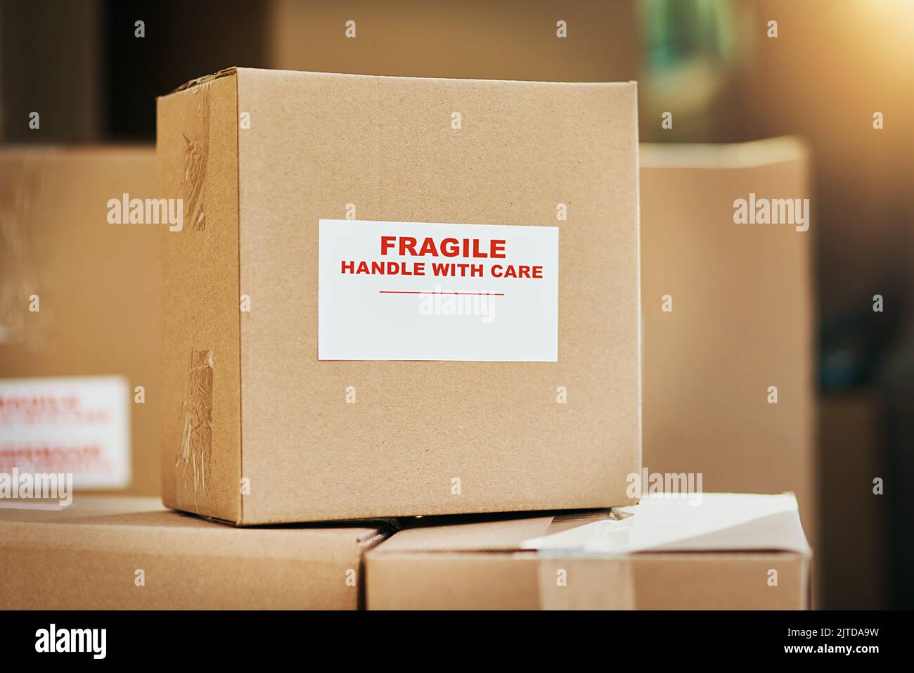 Fragile contents inside. Still life shot of cardboard boxes marked as fragile and ready for delivery. Stock Photo