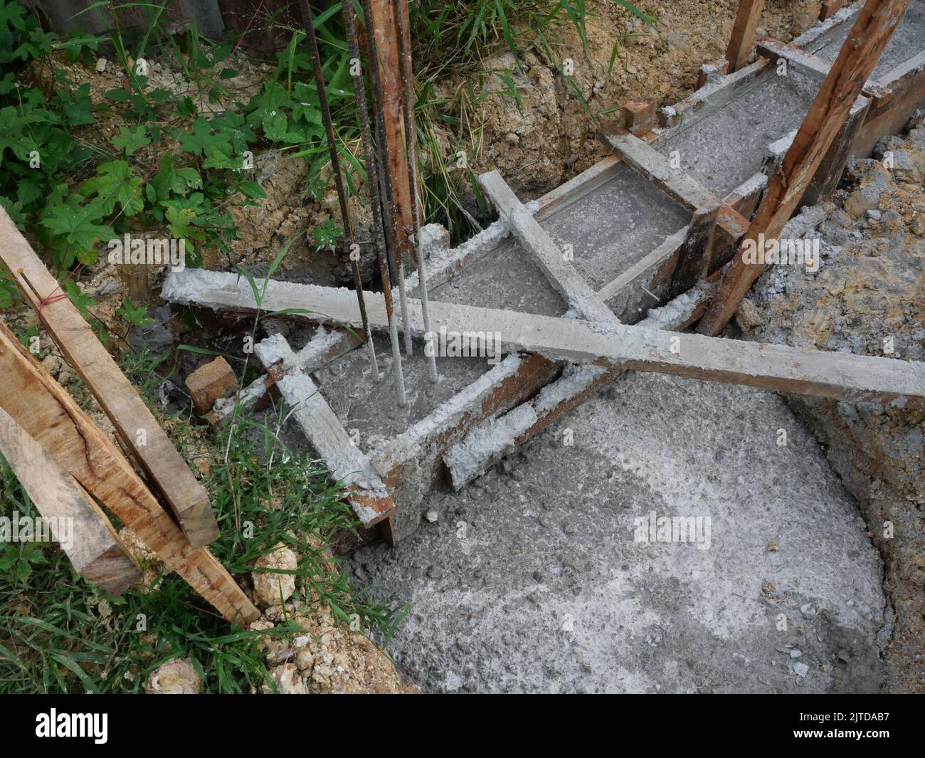 Filling reinforced beam with the concrete reinforcement frame, Timber formwork with metal reinforcement for pouring concrete Stock Photo