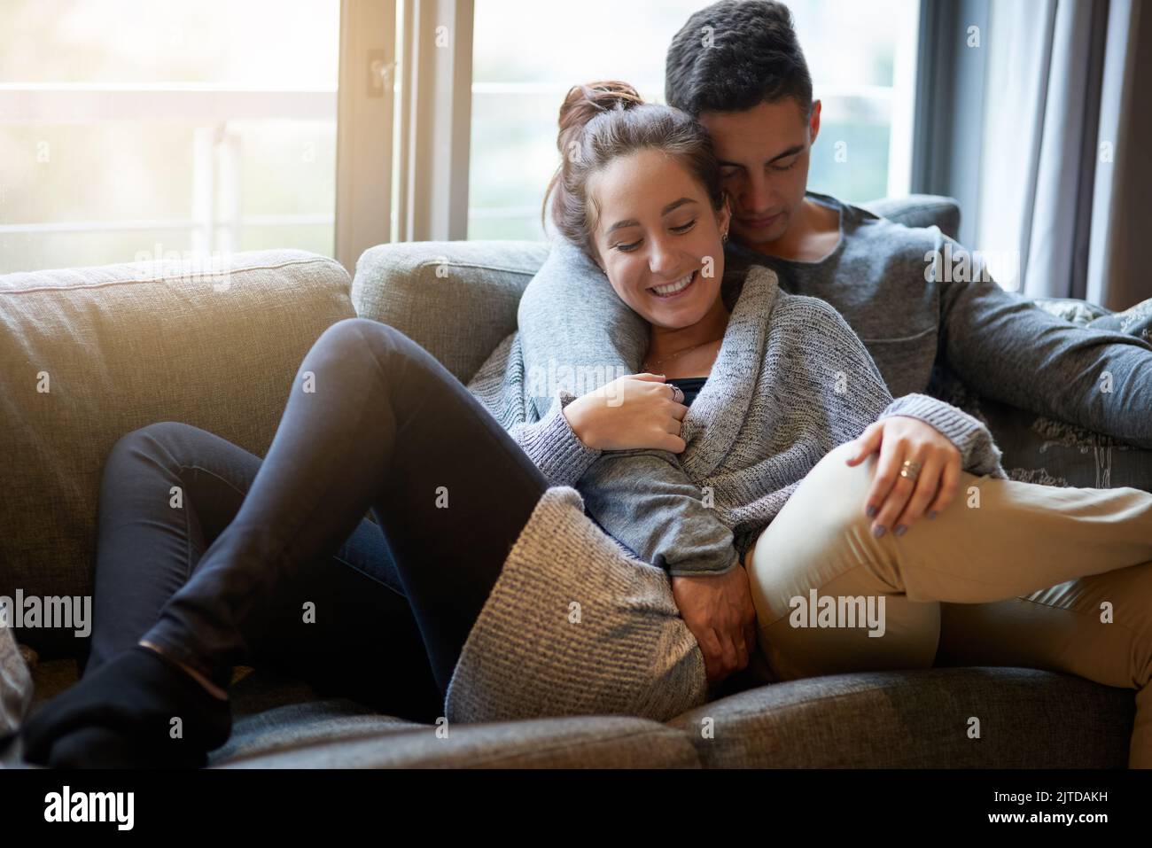 Getting closer with each passing moment. an affectionate young couple relaxing on the sofa at home. Stock Photo