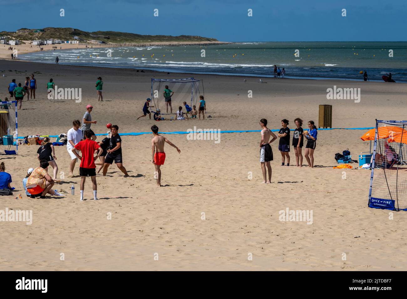 Calais, France - 26 June 2022: Young people playing handball on the beach of Calais during summertime Stock Photo