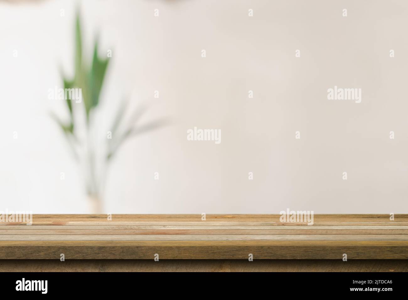Wooden table top with blurred in coffee shop and cafe background for display montage, copy space. Stock Photo