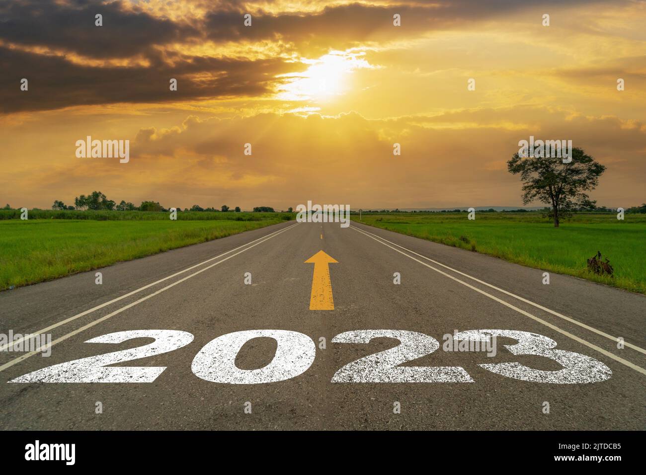 Empty asphalt road and New year 2023 concept. Driving on an empty road to Goals 2023 with sunset. Stock Photo