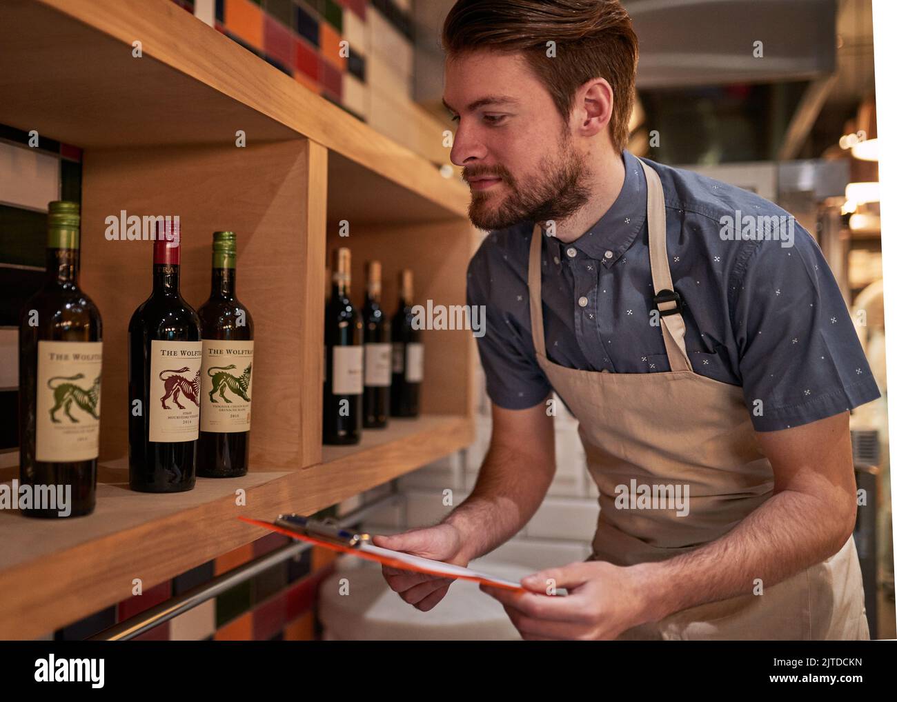 Making sure hes stocked up for the weekend. a young business owner counting his merchandise. Stock Photo