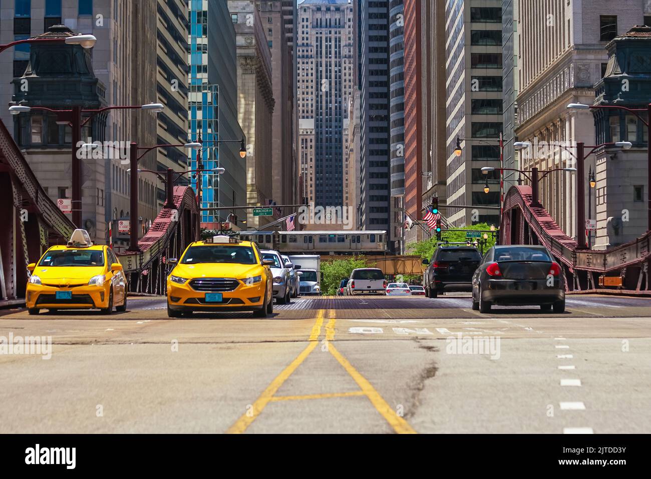 Traffic in downtown Chicago with people, train, car and bus Stock Photo
