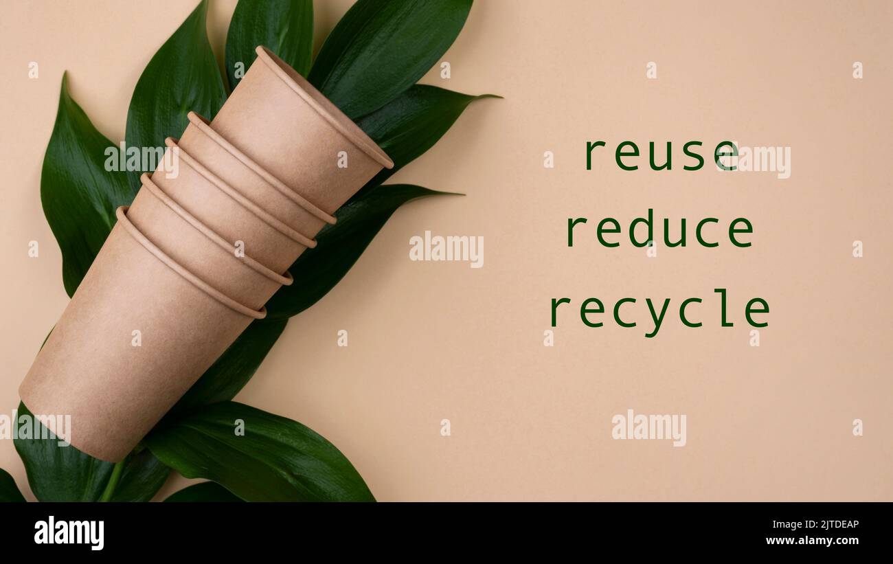 Eco-friendly brown cups leaves with the word Reuse, Reduce and Recycle Stock Photo