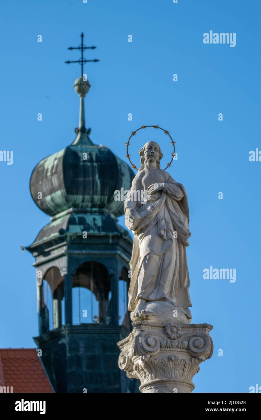 Religious statue with dome topped church Stock Photo