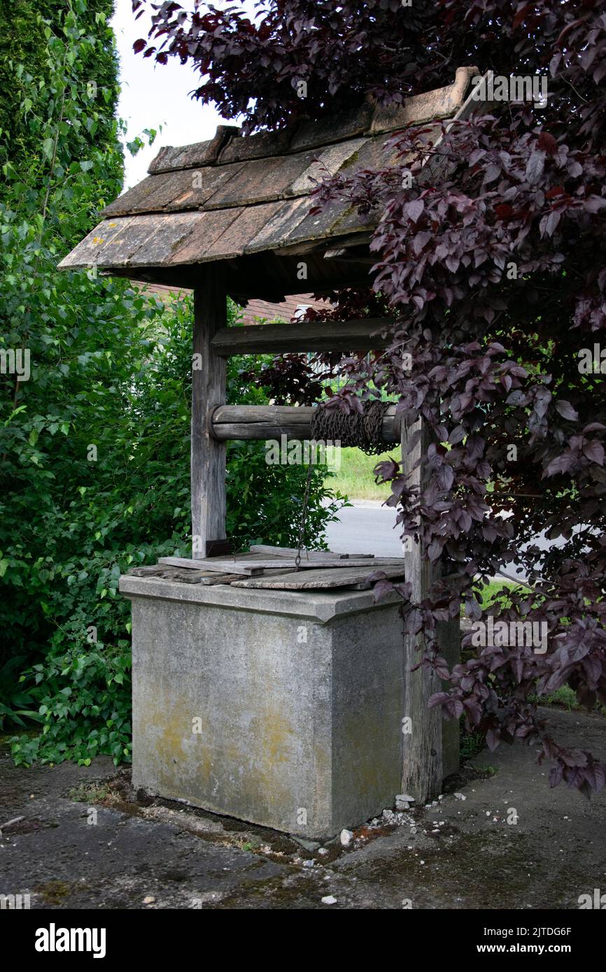 Village well with sloped roof Stock Photo