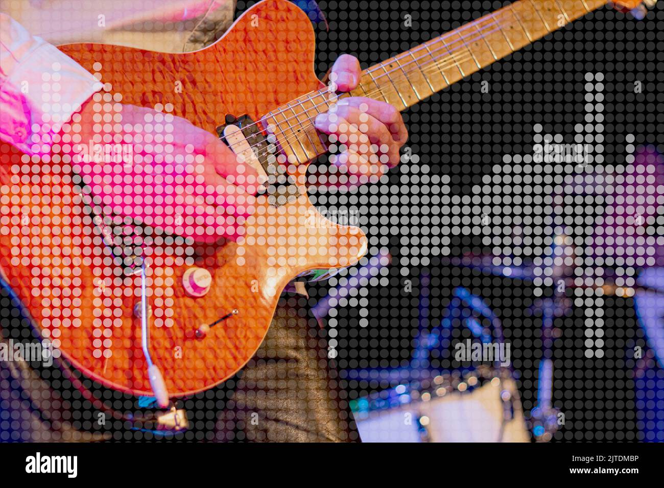 blurry scene from a music stage with guitar player and overlay dotted audio equalizer Halftone effect pattern to promote events Stock Photo